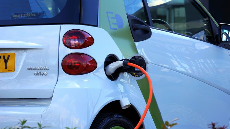 Smart Fortwo electric drive vehicle (from German auto-manufacturer Daimler AG) being charged from a new build property's private EV charging station.