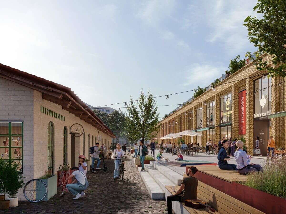 Fliegergasse im Segelflieger Quartier mit Geschäften, Werkstatt, spielenden Kindern und Menschen beim Plaudern.